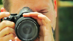 Scott Osmun looking through camera lens